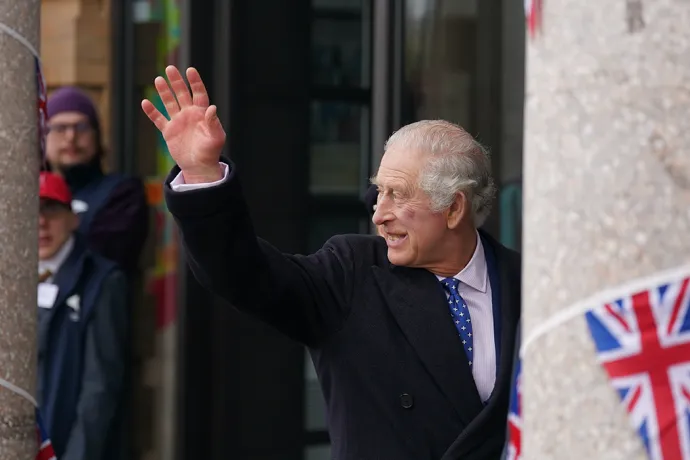 The King waves to crowds