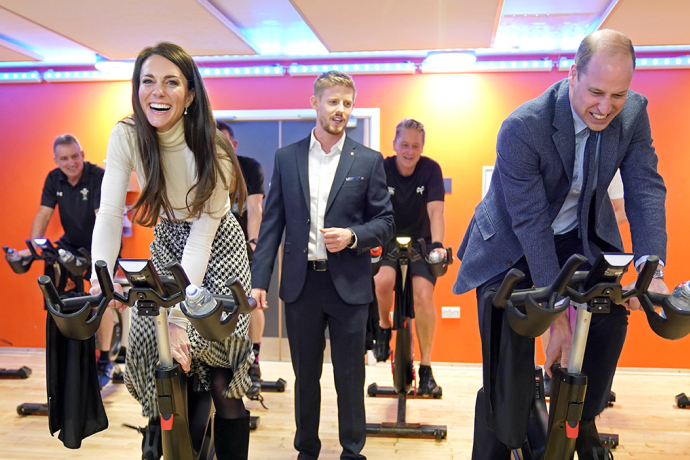 The Prince and Princess of Wales on exercise bikes