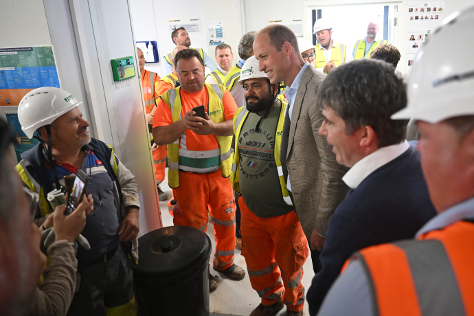 The Prince of Wales speaks with construction workers