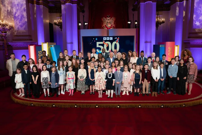 Group photo of The Queen with guests at the 500 Words Reception