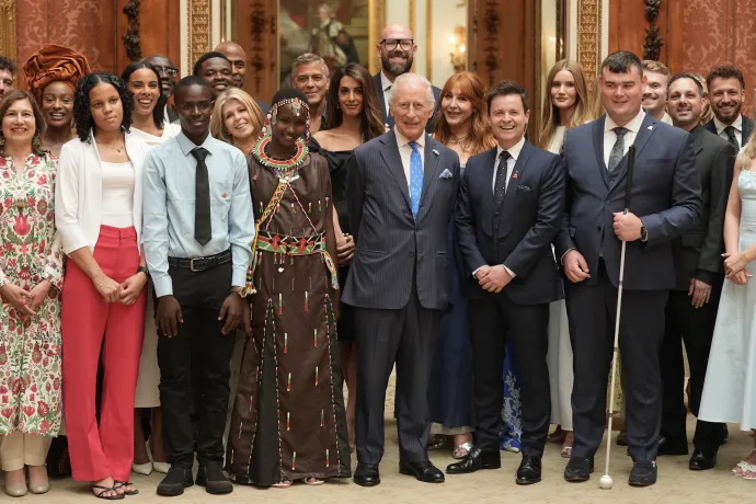 The King smiles alongside King's Trust ambassadors and Awards winners