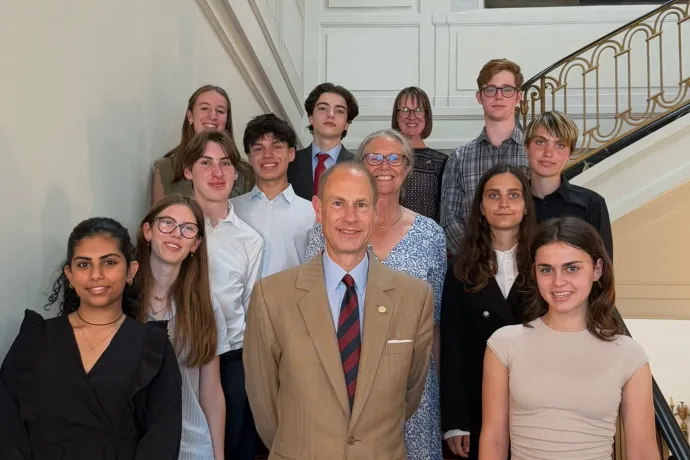 The Duke of Edinburgh smiles alongside IAF Gold Award students 