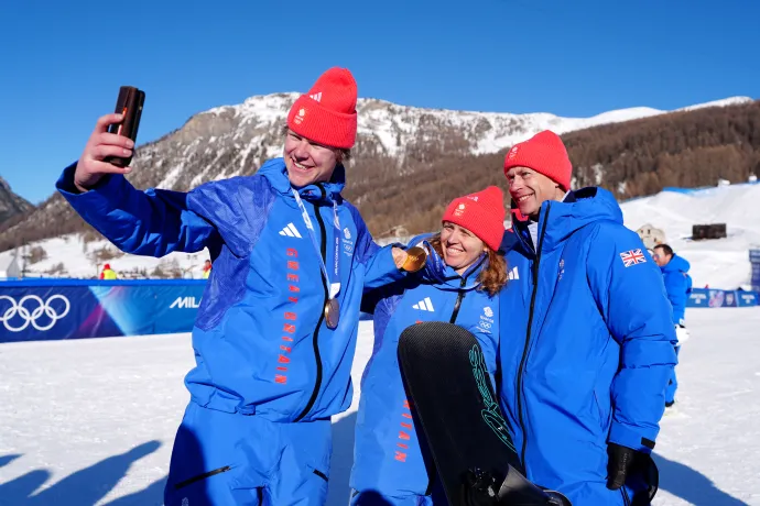 The Duke of Edinburgh smiles for a photo with Team GB athletes Charlotte Bankes and Huw Nightingale