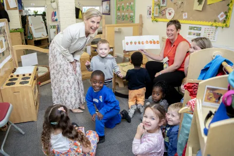 The Duchess of Edinburgh smiles with a group of nursery children